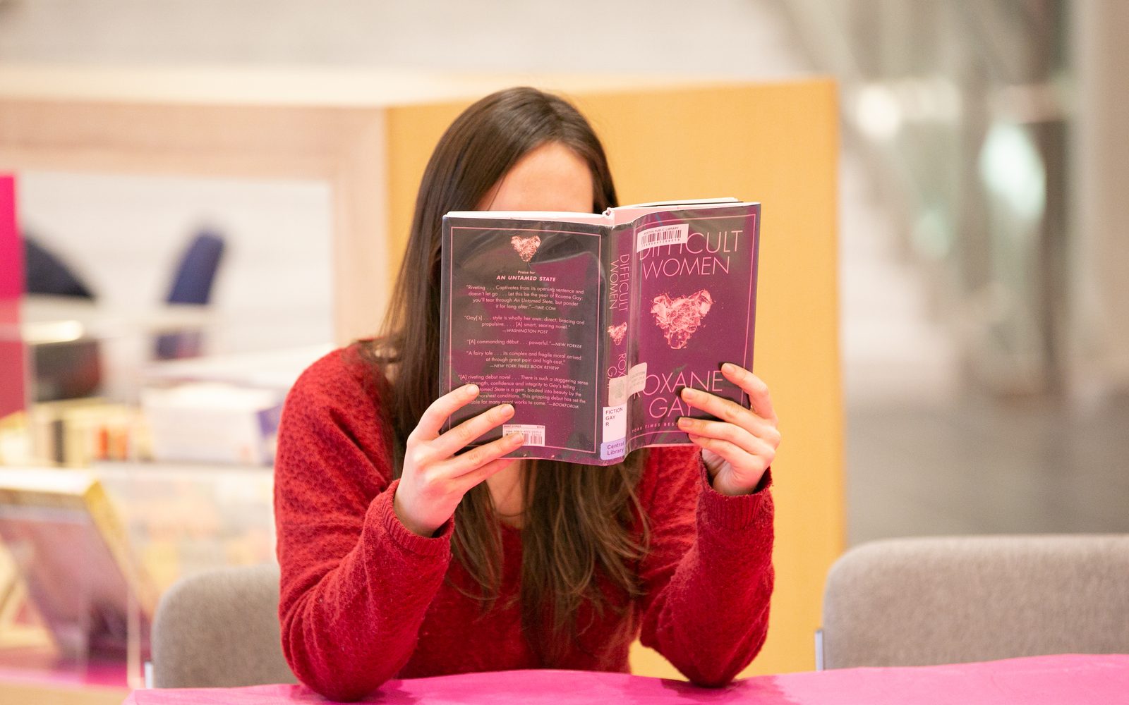 An attendee of White People Read reading Difficult Women by Roxane Gay.